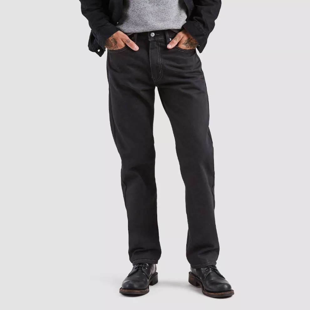 Model wearing black jeans with black dress shoes