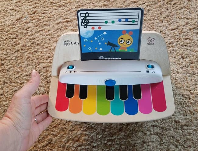 a reviewer photo of the piano with a music note card inserted