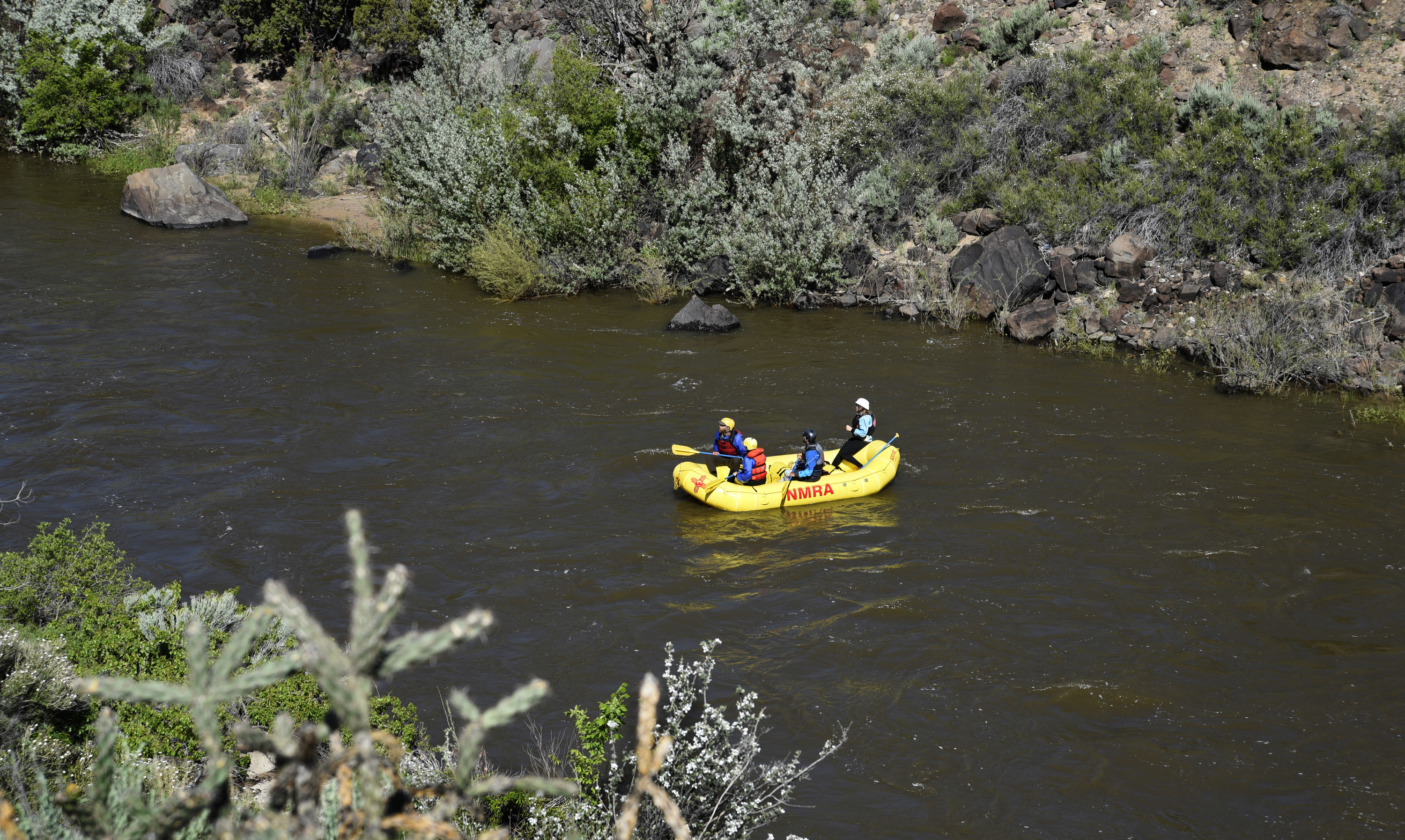 tourist on a raft in the Rio Grande through Taos