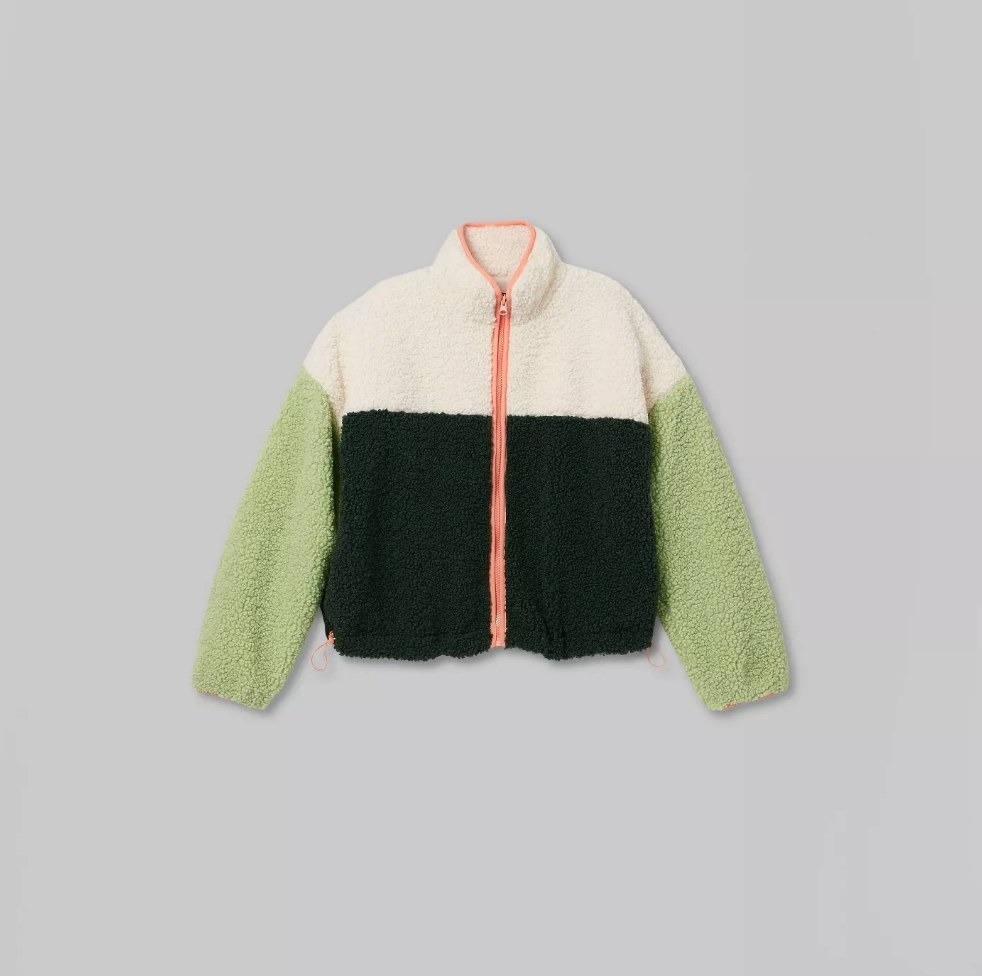 Tri colored sherpa jacket with green sleeves, beige upper, black body