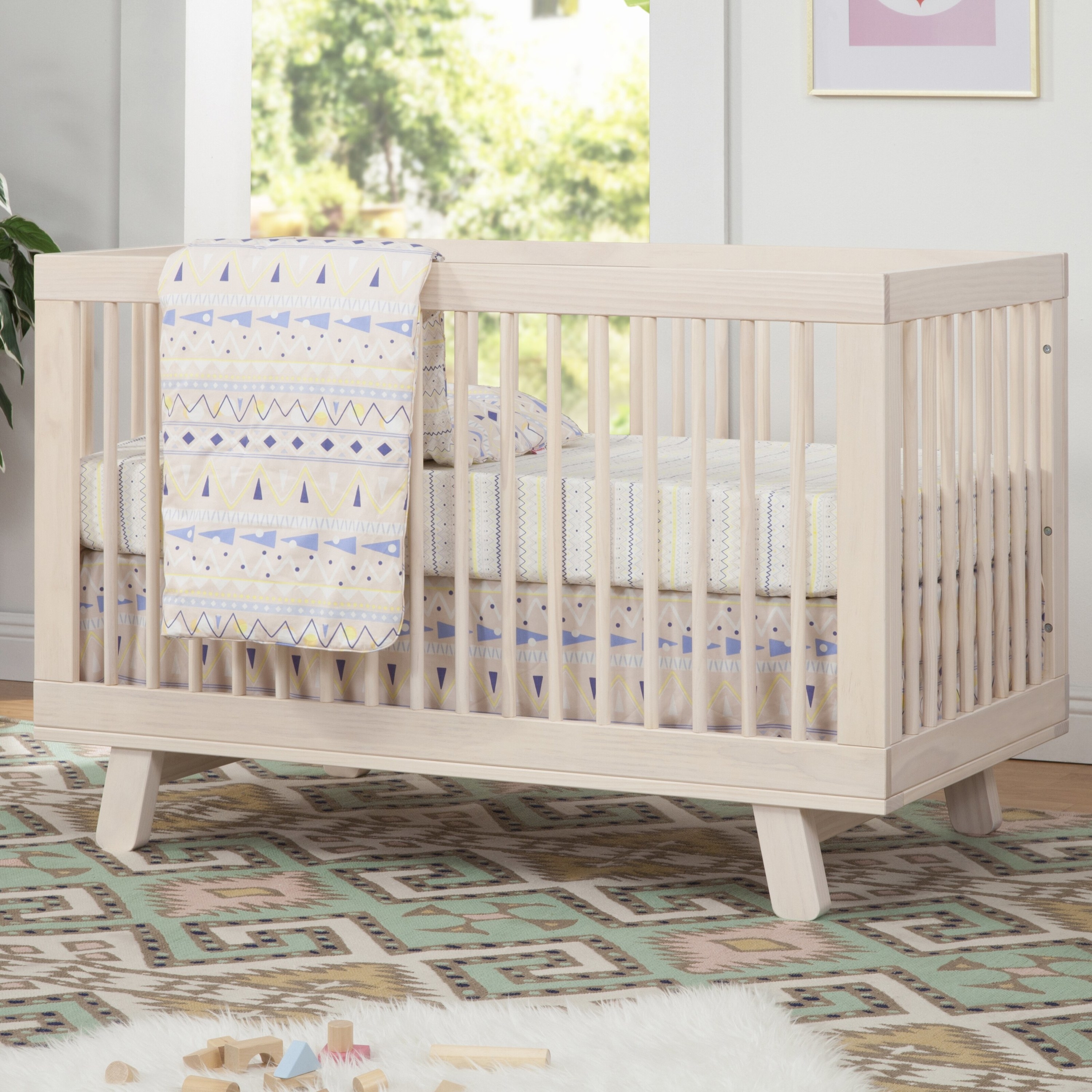 the natural wood crib with geometric sheets