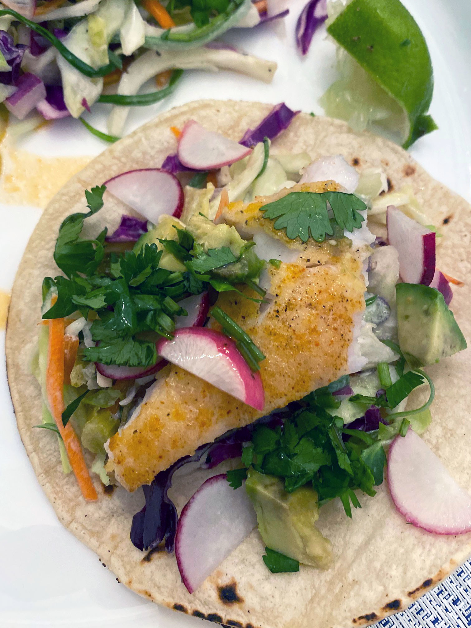 Air-fried, blackened fish tacos with slaw and avocado.