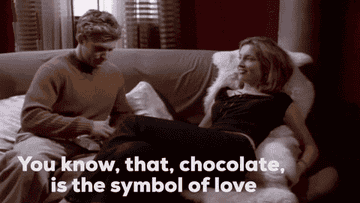 A gif of a person saying &quot;you know, that, chocolate, is the symbol of love&quot; to another person