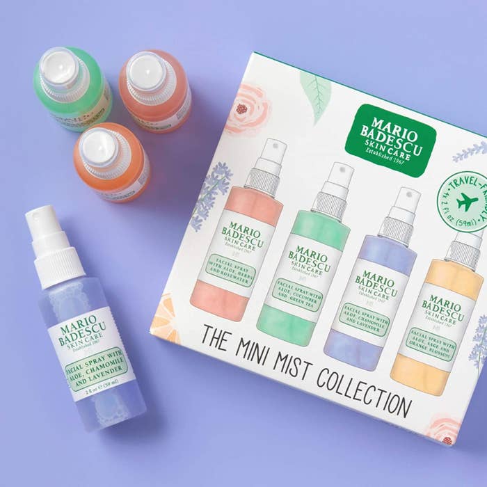 The gift box packaging and the four bottles laying beside it