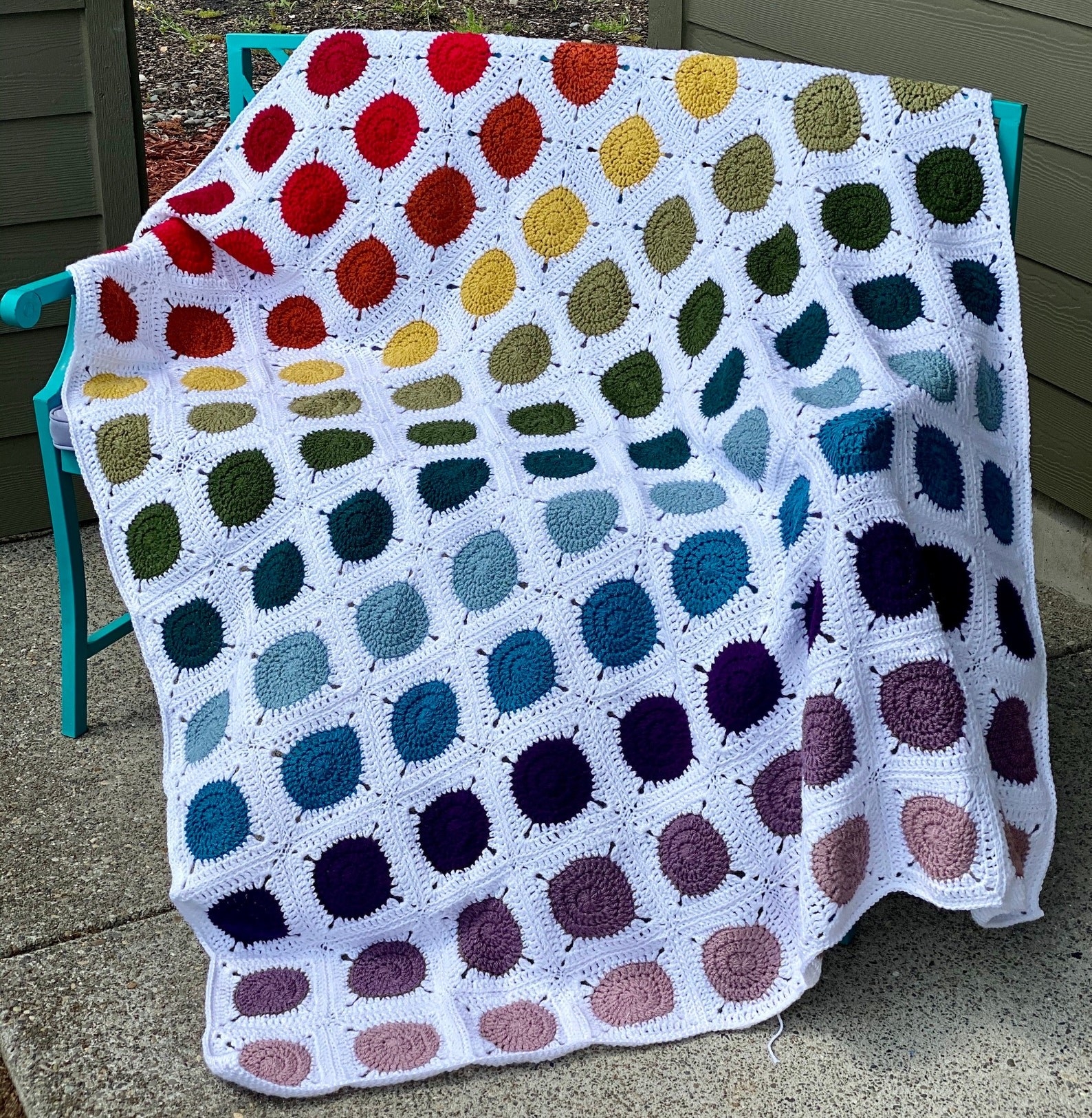 afghan quilt with white border and rows of gradient colorful dots