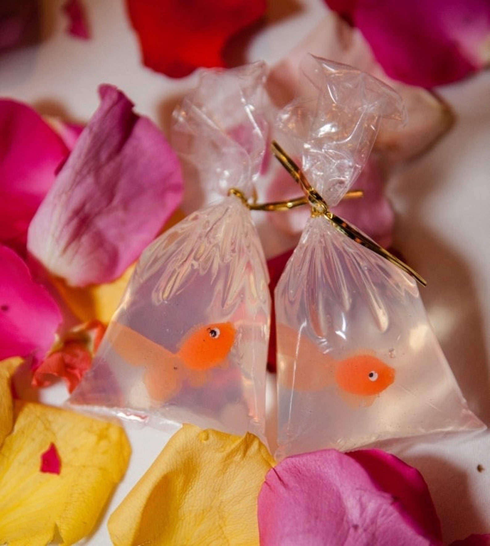 two soaps in bags with plastic goldfish inside