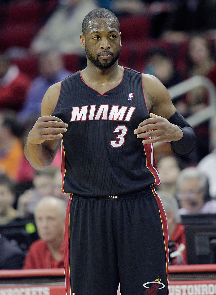 Dwyane Wade stands on the court during a basketball game
