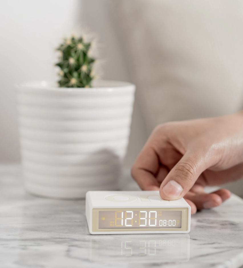 someone turning the petite alarm on