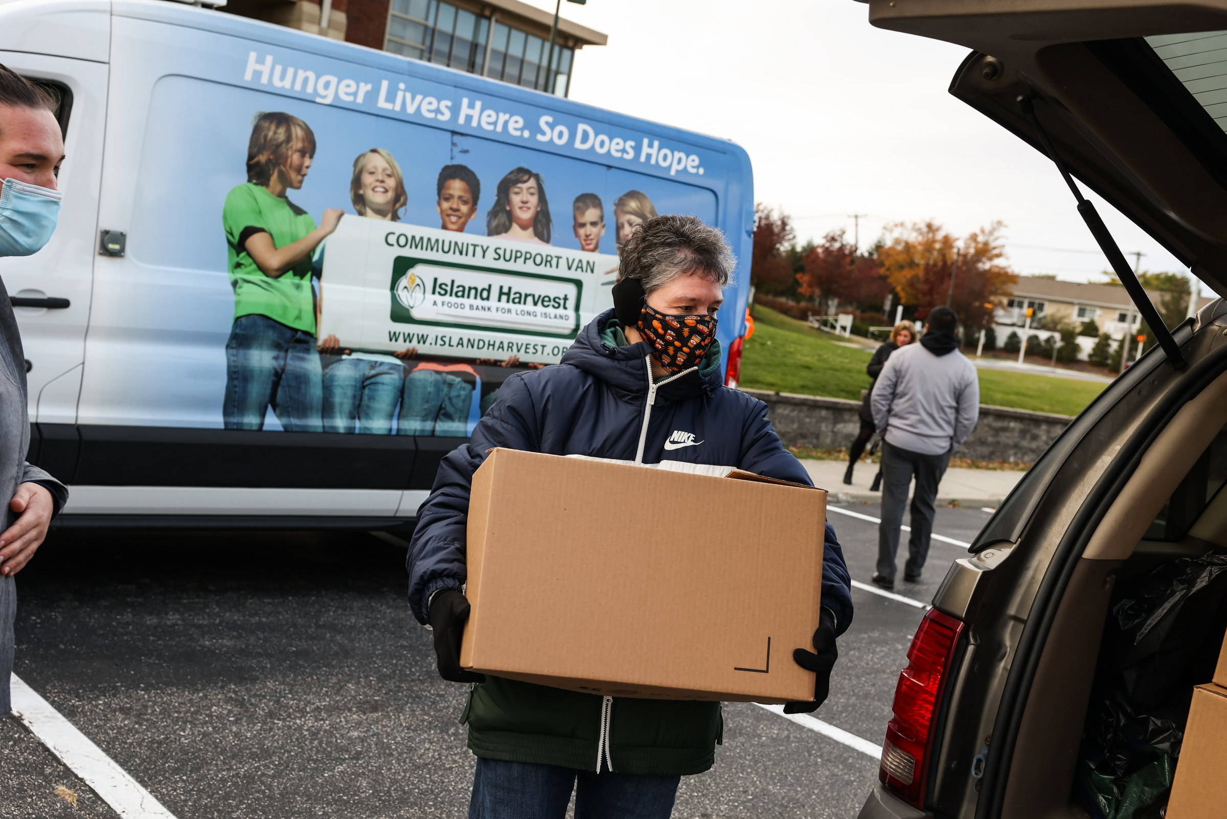 Person donating a box of goods to their community