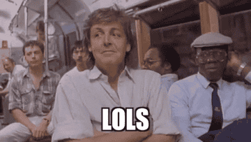 Paul McCartney chuckling on a bus
