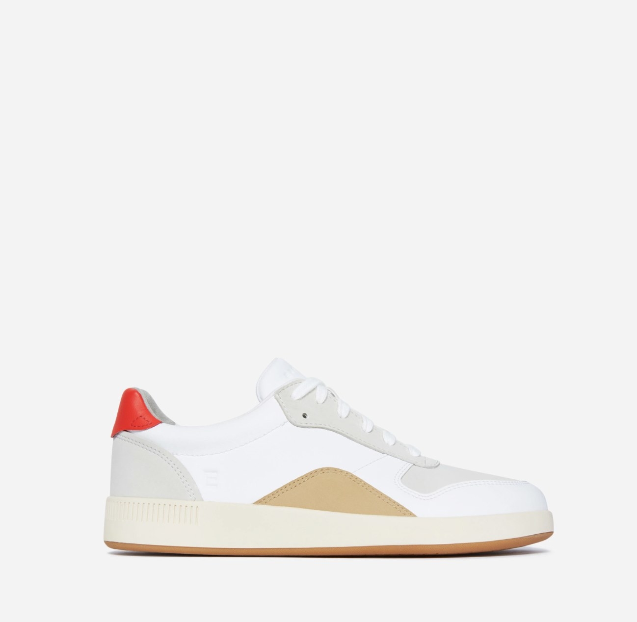 The white tennis court style sneaker with red heel block