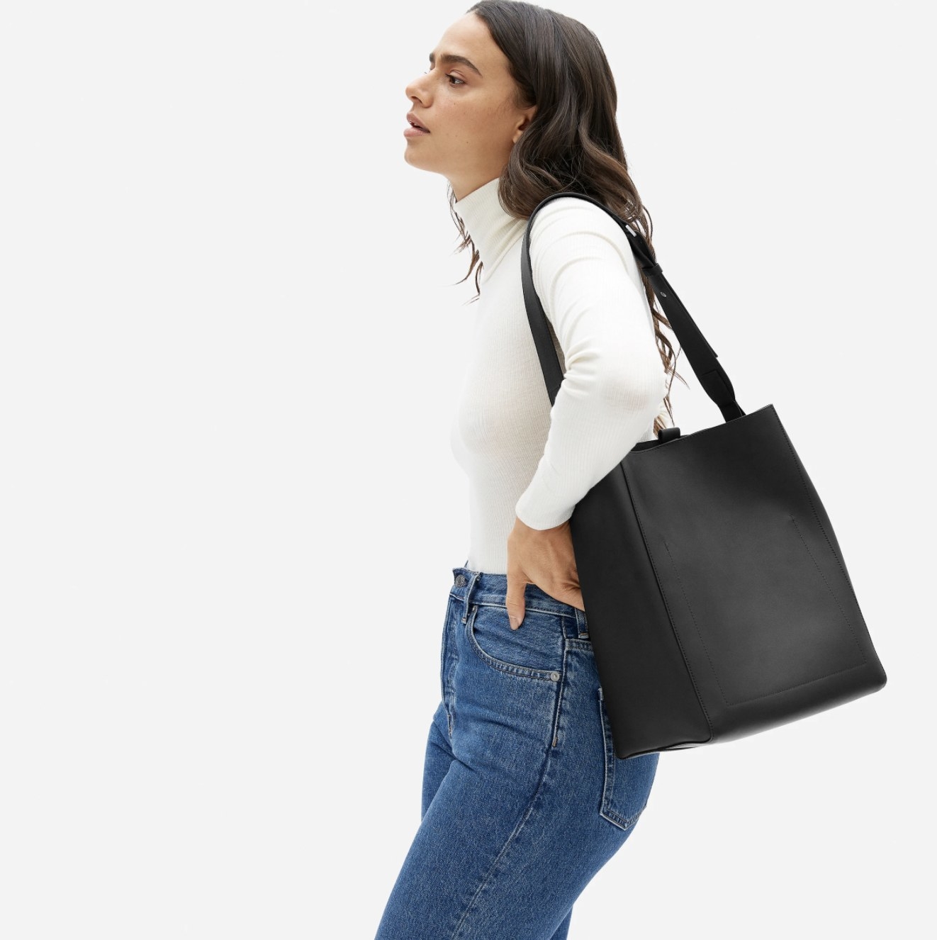 Model wearing the black bag slung over her shoulder