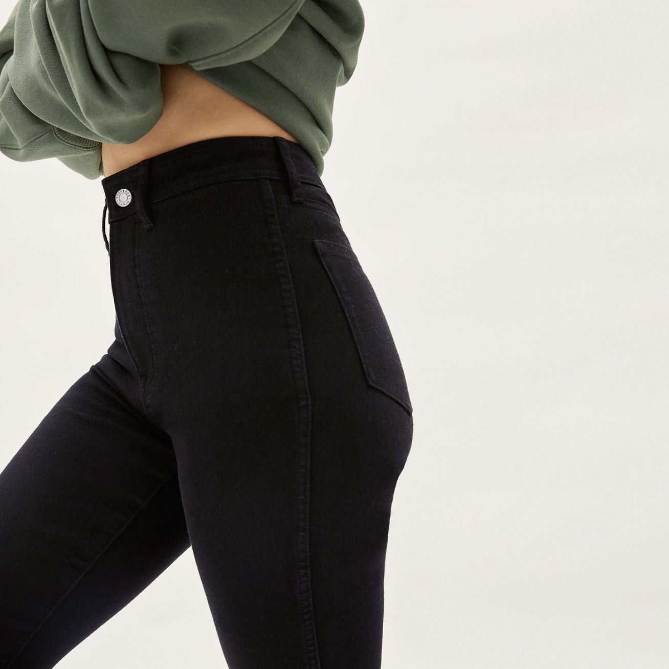 Close-up of model wearing the black high rise jeans