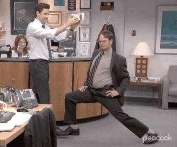 gif of jim from the office putting a tin foil crown on dwight