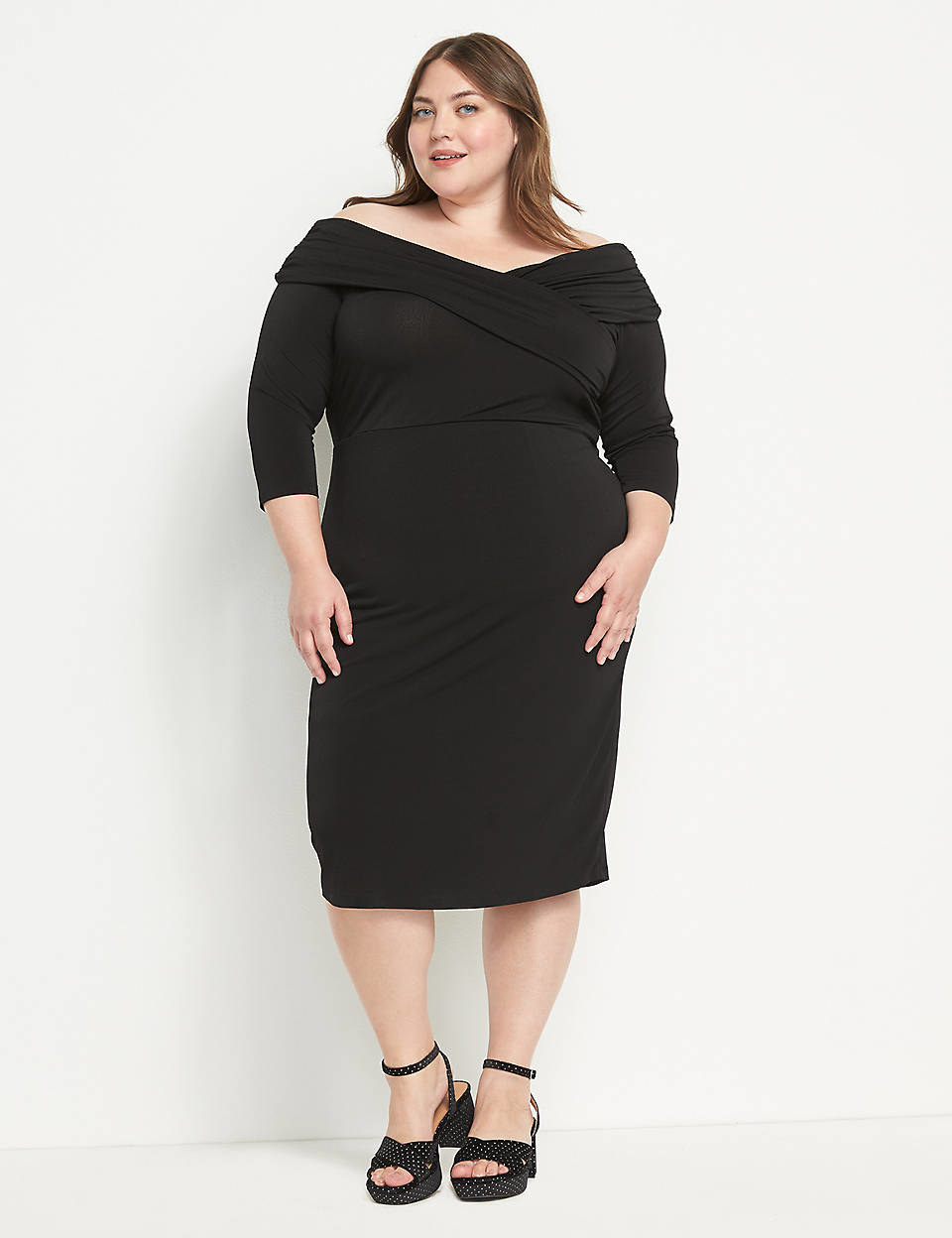model wearing the off-the-shoulder dress in black