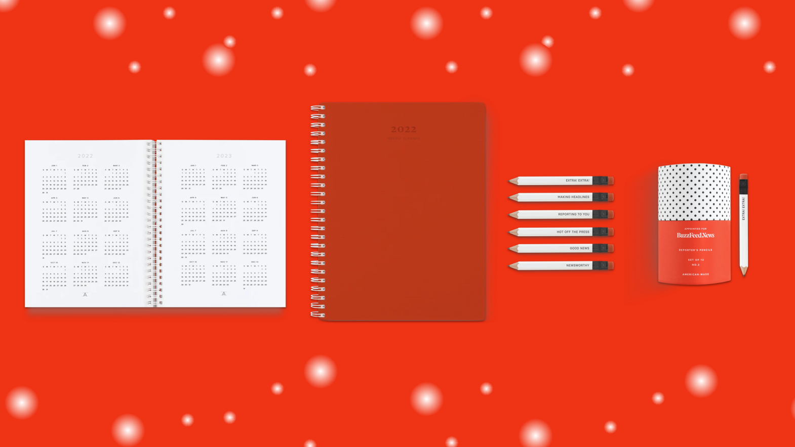 Planner and pencils on a red background.