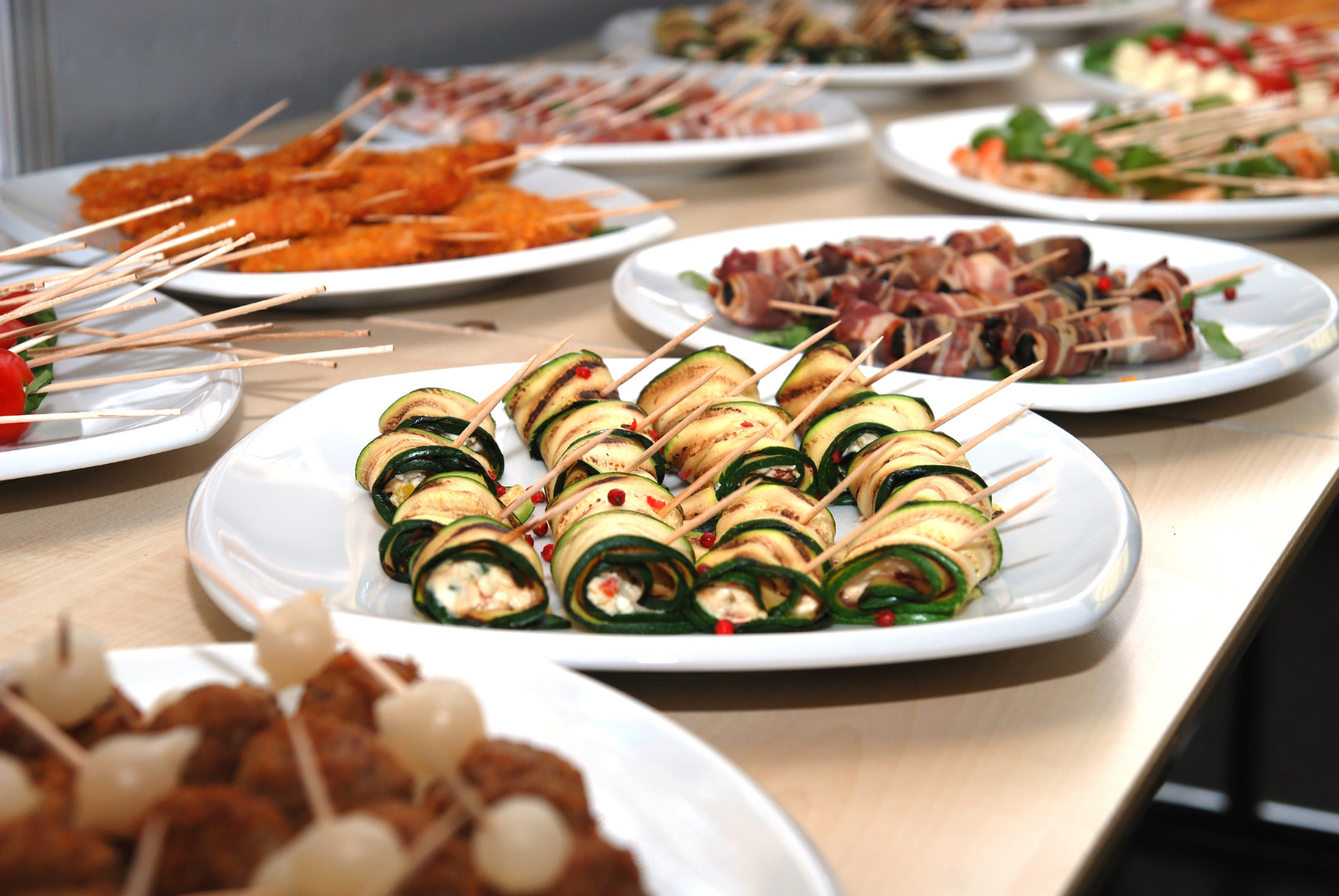 A buffet table with lots of finger food and appetizers