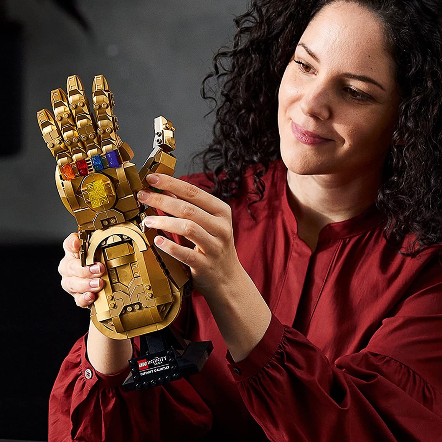 someone assembling the lego infinity gauntlet
