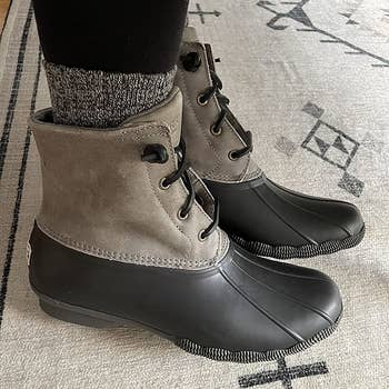 Reviewer wearing gray and black boots
