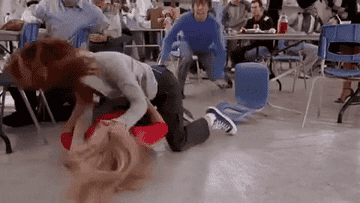 Cady and Regina fighting on the cafeteria floor