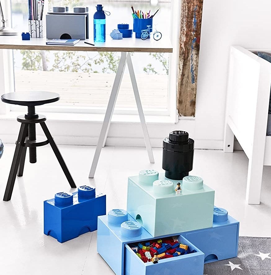 a set of lego block shaped storage boxes filled with small lego blocks