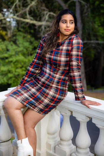 Reviewer wearing the blue, black, and red plaid dress