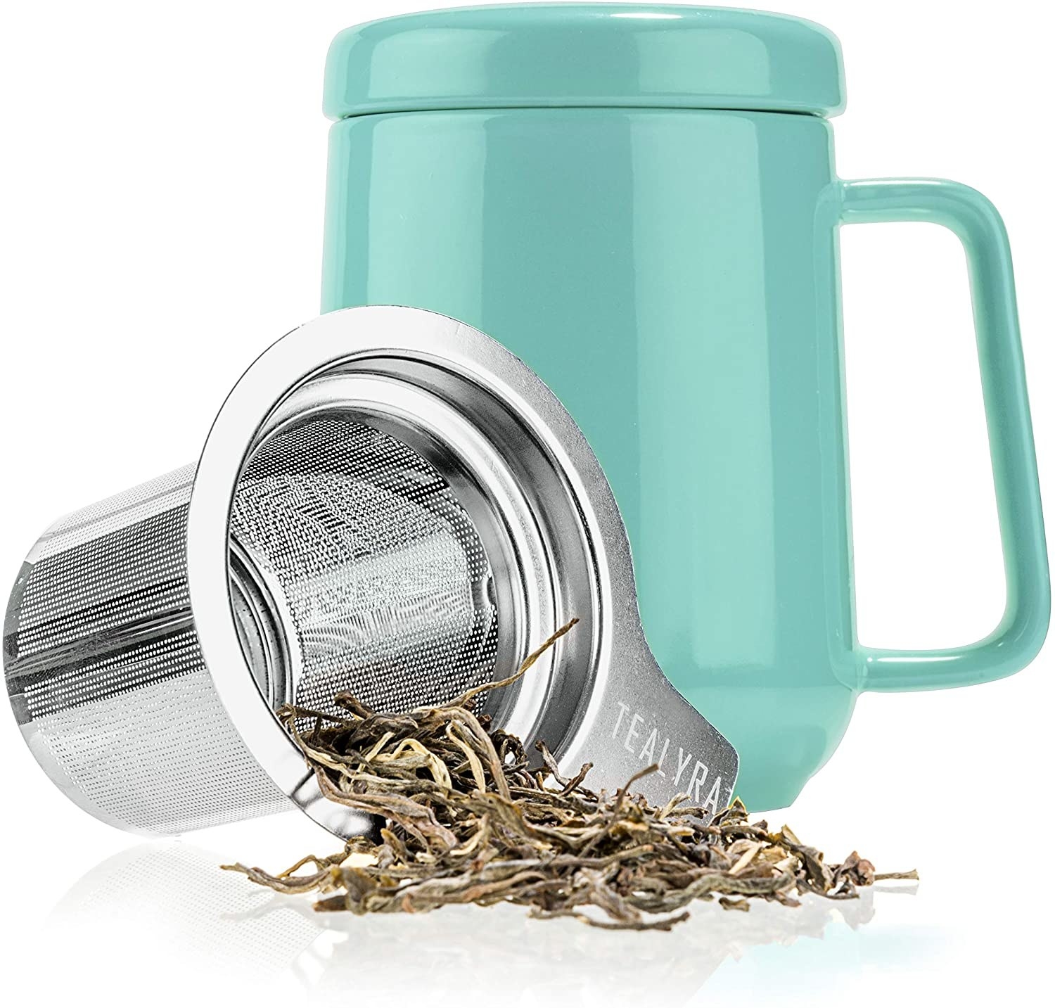A ceramic mug with a metal infuser next to it