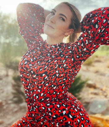 Close-up of reviewer wearing the red leopard print dress