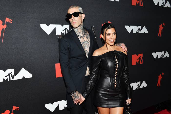 Travis and Kourtney holding hands at the MTV VMA's