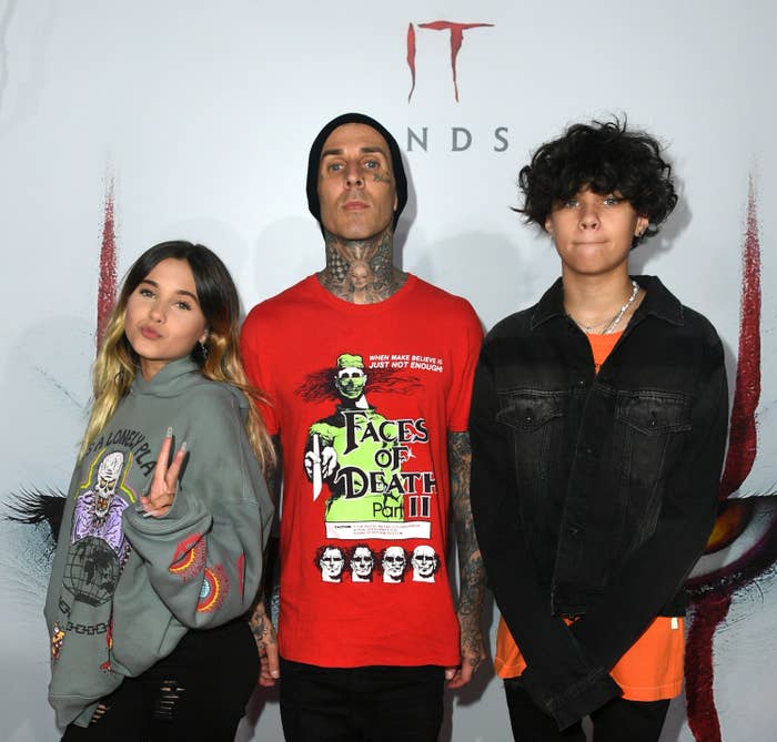 Travis and his two kids pose for photos at an event