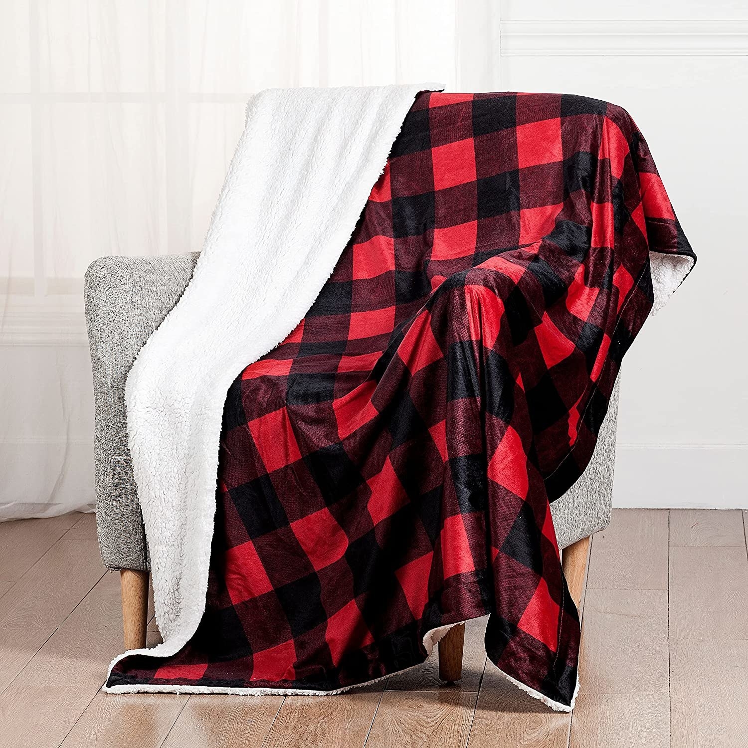 A knit blanket draped over a chair