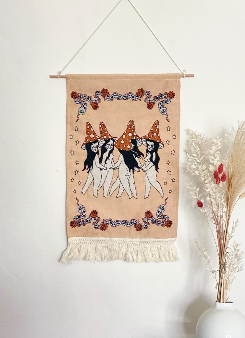 the tapestry which has five dancing figures wearing mushroom hats