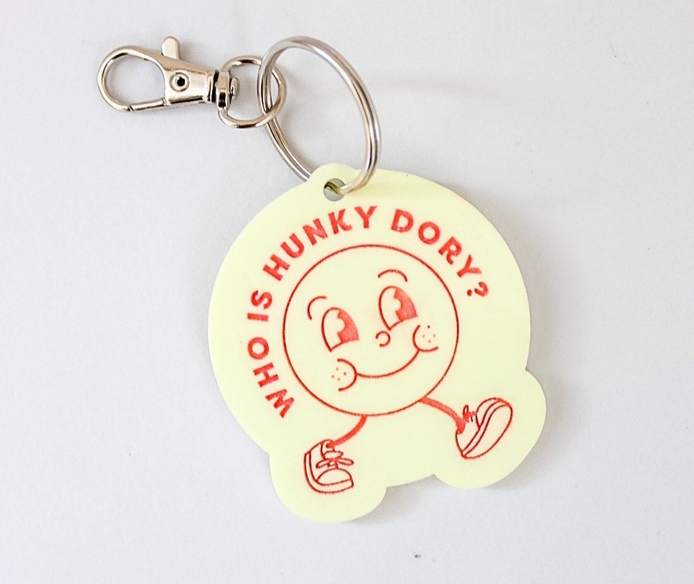 light yellow keychain that says &quot;who is hunky dory&quot; on it
