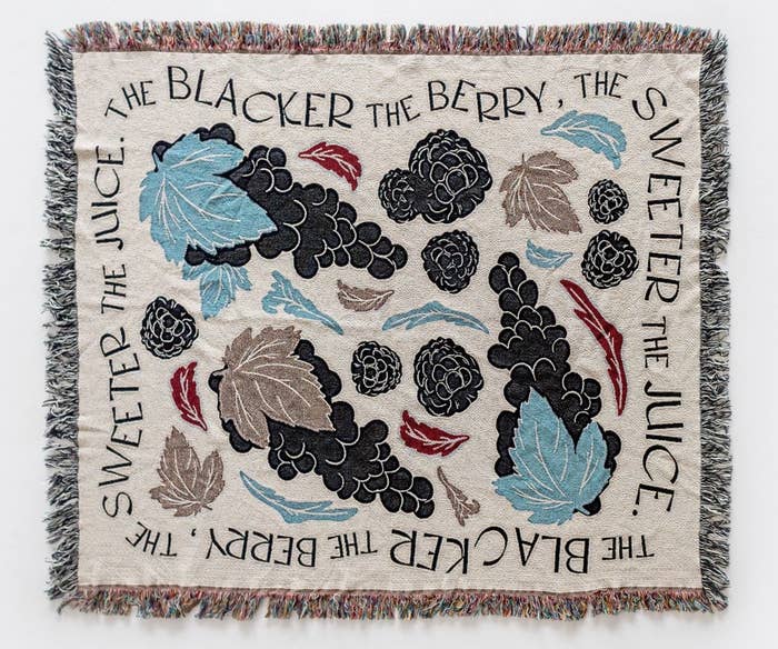 the fringed blanket which says &quot;the blacker the berry, the sweeter the juice&quot;