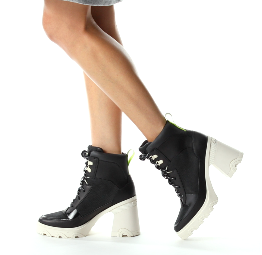 model wearing the chunky heel lace-up boots in black and white