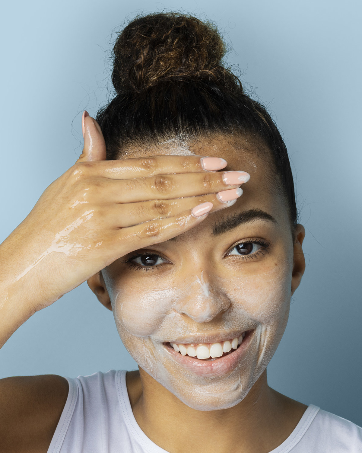 a model with the cleanser on their face