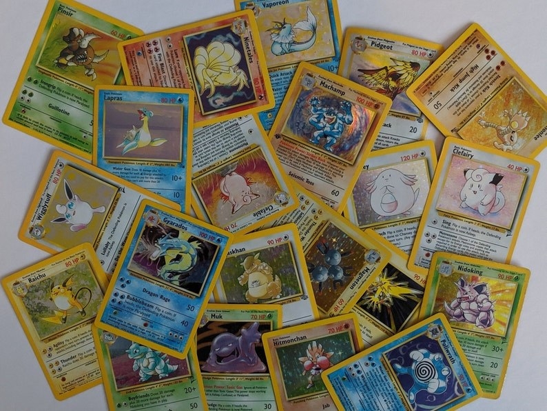 A bunch of Pokemon cards on a table