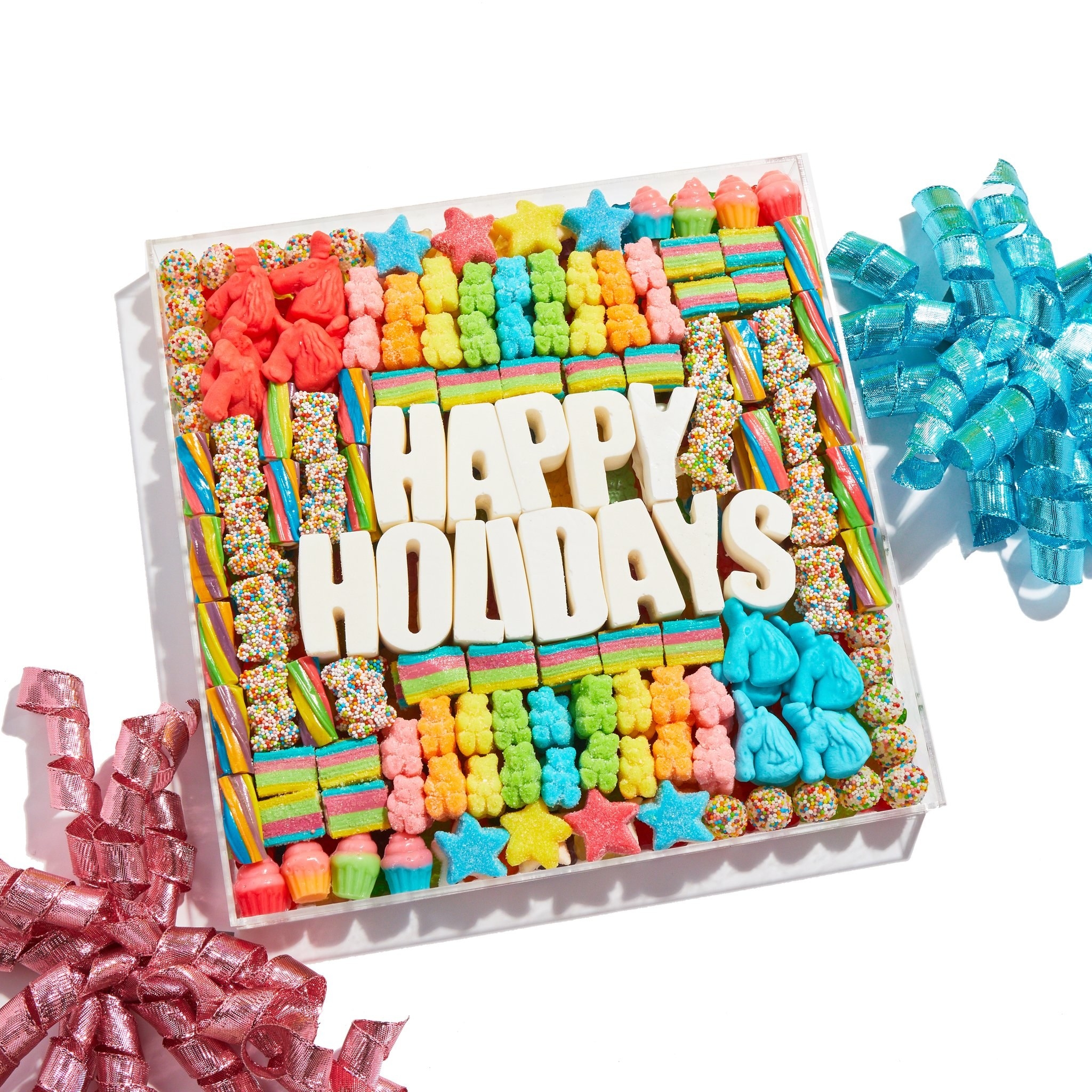a board with happy holidays spelled out with candy