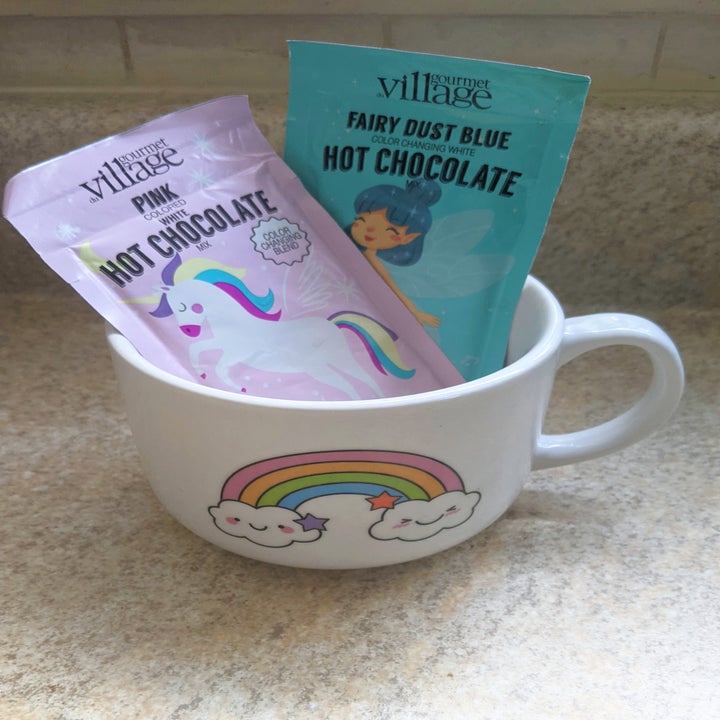 Two packets of hot chocolate mix in a mug