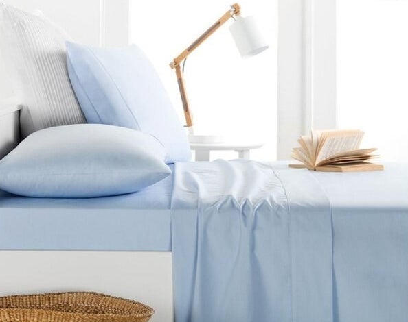 Blue sheet set on a bed