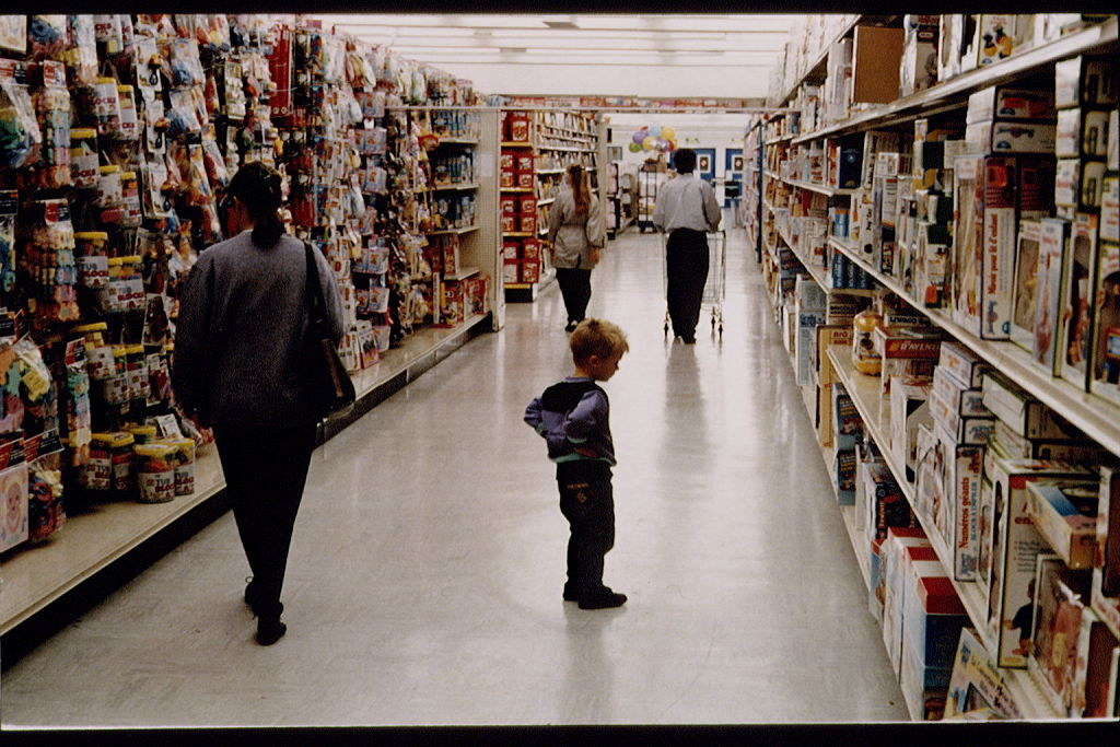 Photo of a little boy looking at toys inside a Toys &quot;R&quot; Us