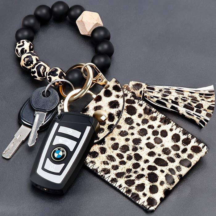 the keychain in leopard with a black and leopard print beaded bracelet