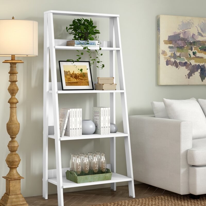 Ladder bookcase filled with books and accessories