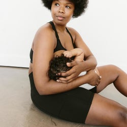 model nursing baby wearing bra, sitting down