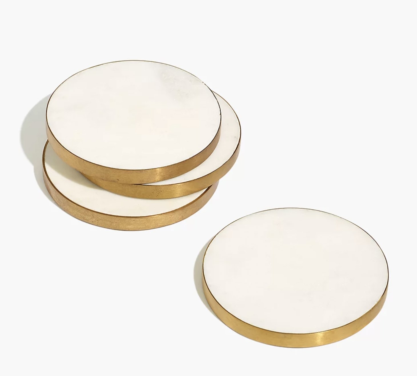 a set of four marble coasters with gold rims