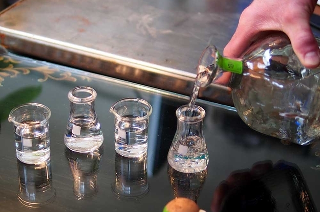 The four shot glasses shaped like beakers and erlenmeyer flasks