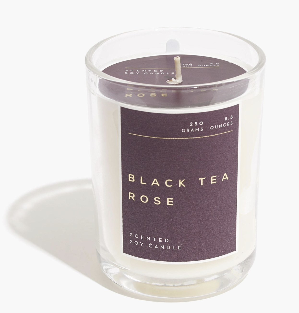 the black tea rose candle with a purple label