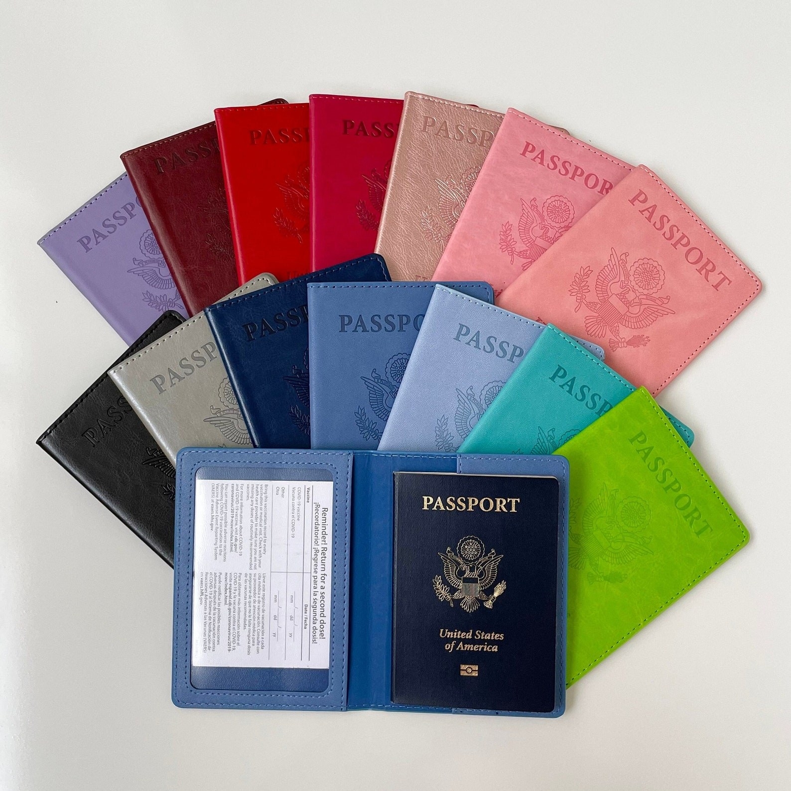 the blue holder open with a vaccine card behind a clear sleeve on one side and a passport on the other side