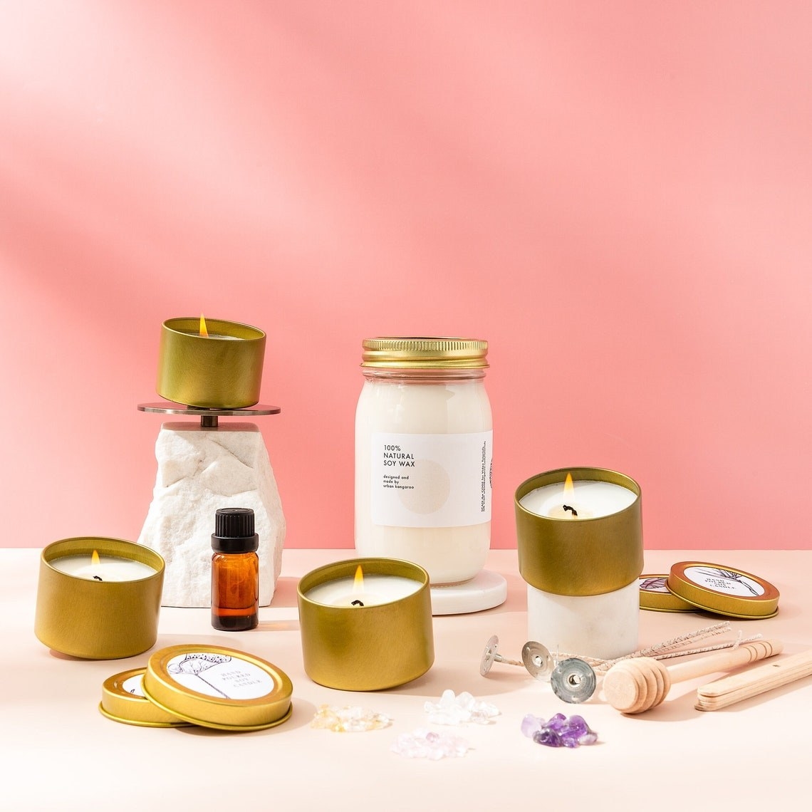 the whole candle kit with it's included items and four finished candles lit