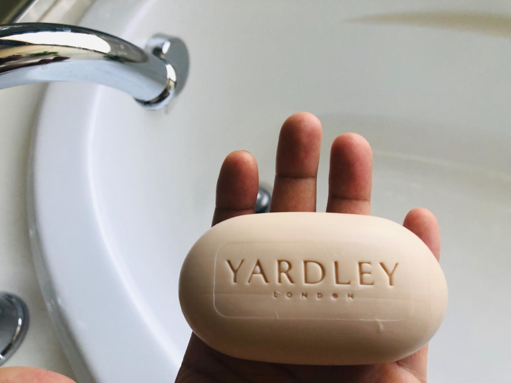 a reviewer photo of a hand holding the bar of soap